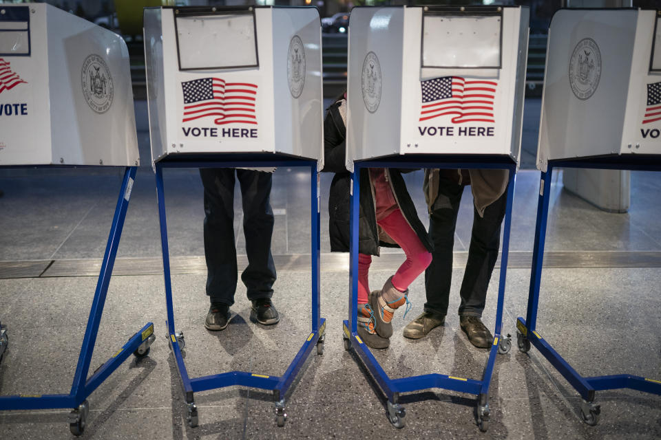Voters fill out their ballots before bringing them to counting machines at a polling site in the Brooklyn Museum as the doors open for the midterm election, Tuesday, Nov. 8, 2022, in the Brooklyn borough of New York. (AP Photo/John Minchillo)