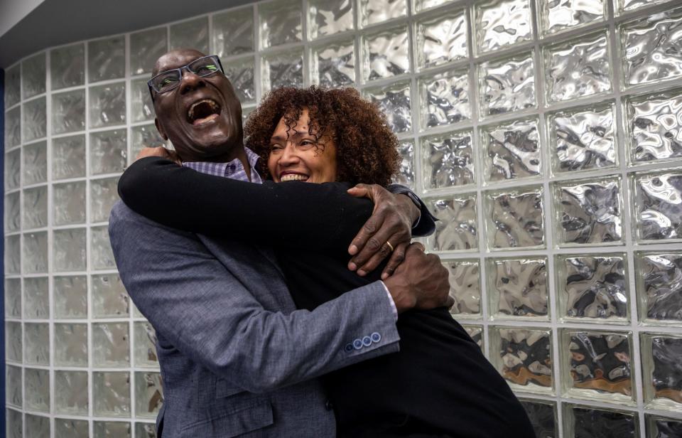 Luther Bradley, the Detroit Lions' first-round draft pick 45 years ago, smiles as his wife Sylvia Shelby Bradley hugs him inside the Blue Cross Blue Shield (BCBSM) of Michigan headquarters in Detroit on Tuesday, April 25. Following his football career, Bradley was hired by BCBSM in 1989 as a marketing representative and today BCBSM values his expertise as a consultant.