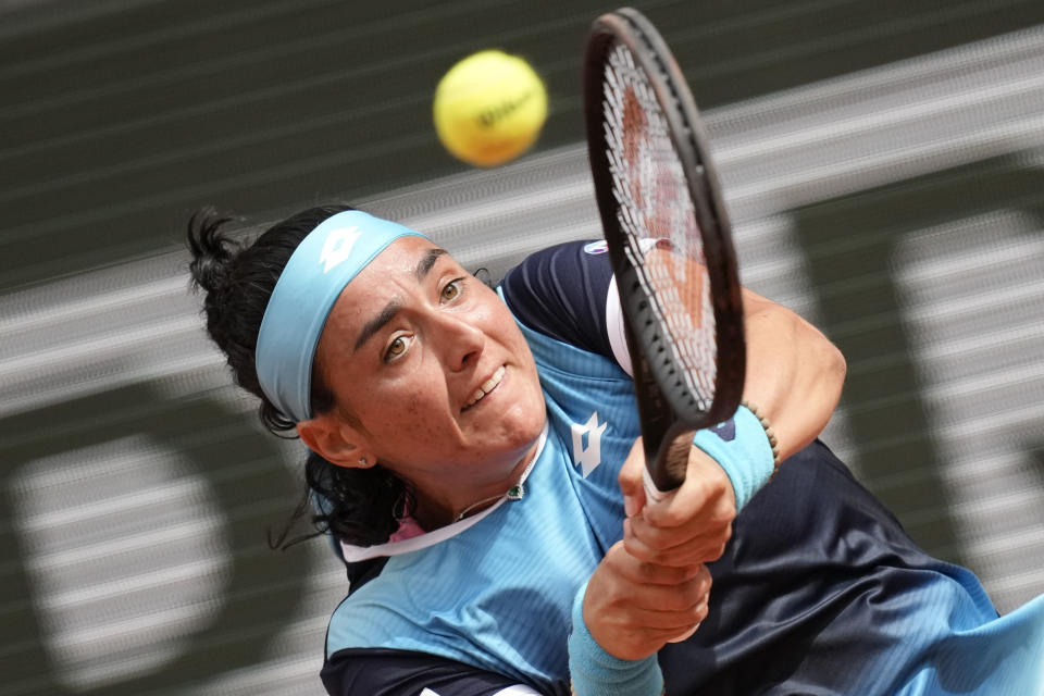 Tunisia's Ons Jabeur plays a shot against Poland's Magda Linette during their first round match at the French Open tennis tournament in Roland Garros stadium in Paris, France, Sunday, May 22, 2022. (AP Photo/Christophe Ena)