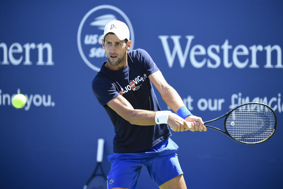 Novak Djokovic hits a tennis ball.