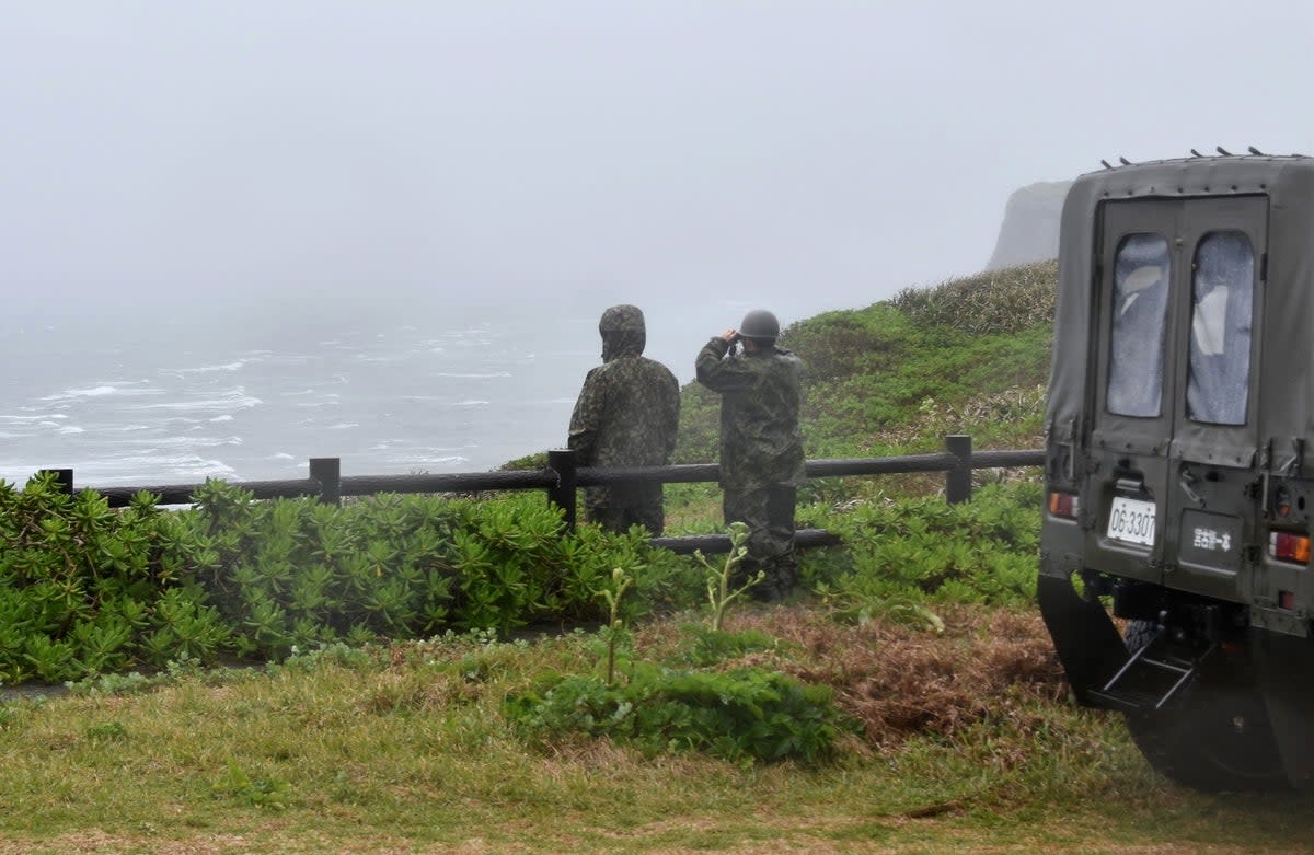 Japan’s Ground Self-Defence Force personnel look out from the northern top of Irabu Island (EPA)