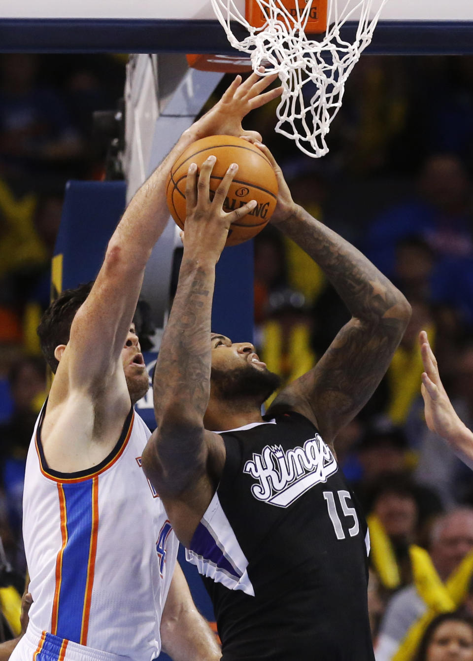 Sacramento Kings center DeMarcus Cousins (15) shoots in front of Oklahoma City Thunder forward Nick Collison (4) in the fourth quarter of an NBA basketball game in Oklahoma City, Sunday, Jan. 19, 2014. Oklahoma City won 108-93. (AP Photo/Sue Ogrocki)