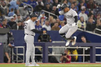 New York Yankees' Juan Soto celebrates with third base coach Luis Rojas after hitting a solo home run during the eighth inning of a baseball game against the Toronto Blue Jays in Toronto, Wednesday, April 17, 2024. (Chris Young/The Canadian Press via AP)