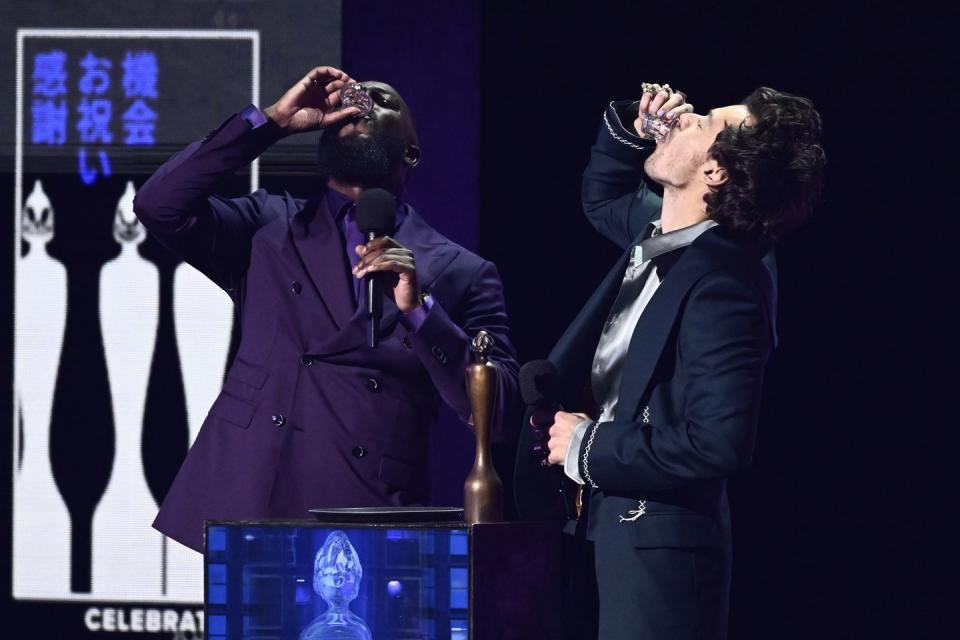 mo gilligan and harry styles drink a shot at the brit awards