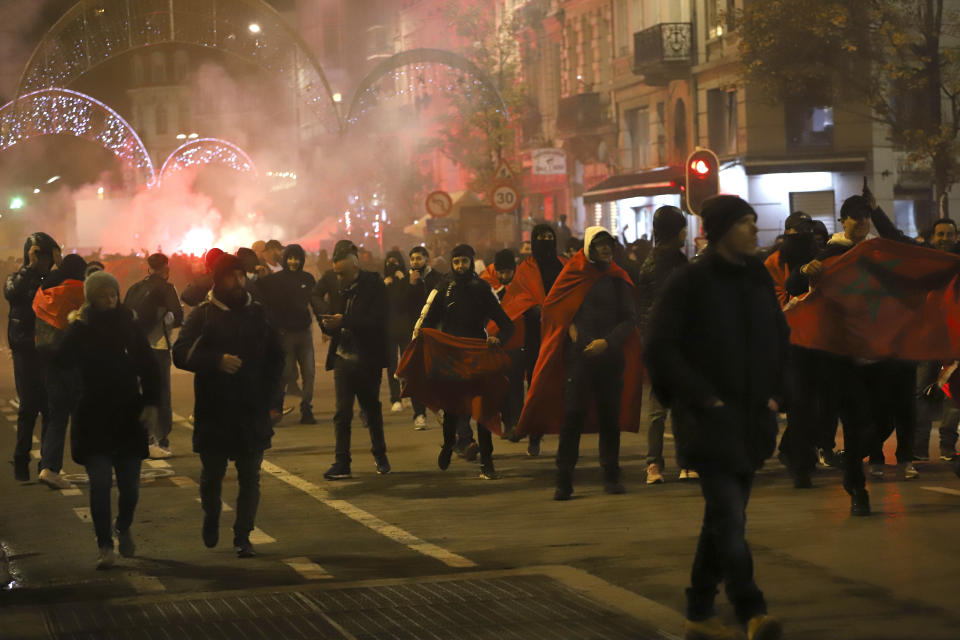 FILE - Soccer fans celebrate Morocco's win after the World Cup round of 16 soccer match between Morocco and Spain, which was played in Qatar, in the center of Brussels, Tuesday, Dec. 6, 2022. (AP Photo/Valeria Mongelli, File)