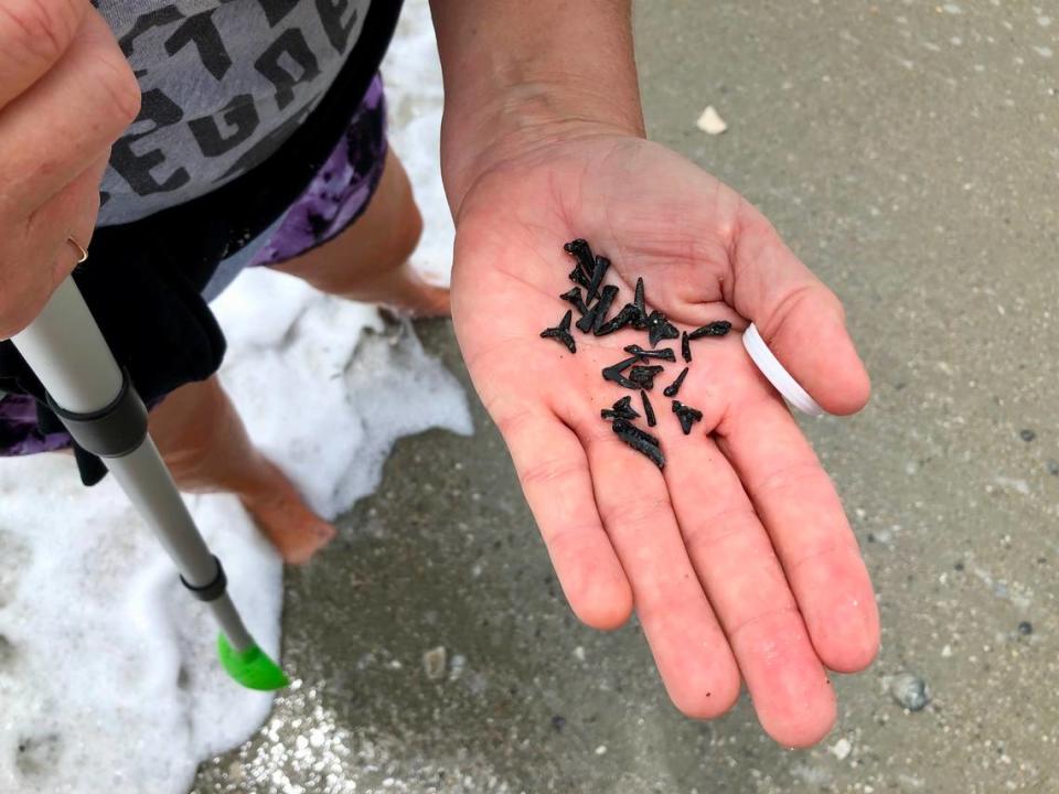 Robin Smith of Carolina Forest showed her shark tooth finds. After a weekend of wet weather, people took to the beach on Memorial Day. May 29, 2023.