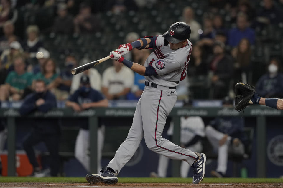 Minnesota Twins' Trevor Larnach hits an RBI-single to score Jorge Polanco during the first inning of a baseball game against the Seattle Mariners, Monday, June 14, 2021, in Seattle. (AP Photo/Ted S. Warren)