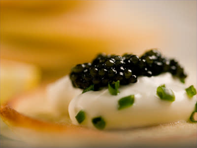 <b>This might be what yo­u think of when you think of traditional caviar — mmm, caviar, chives and crème fraiche — but the technique of spherification invented an all-new kind of caviar.</b> C Squared Studios/<a class="link " href="http://www.gettyimages.com" rel="nofollow noopener" target="_blank" data-ylk="slk:Getty Ima­ges;elm:context_link;itc:0;sec:content-canvas">Getty Ima­ges</a>