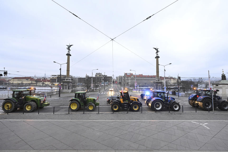 A convoy of tractors drives on a embankment during a farmers' protest in Prague, March 7, 2024. Czech farmers have blocked traffic in Prague, cramming the streets with hundreds of tractors and other vehicles as they rallied against the government and agriculture policies set by the European Union.(Katerina Sulova/CTK via AP) ** SLOVAKIA OUT **