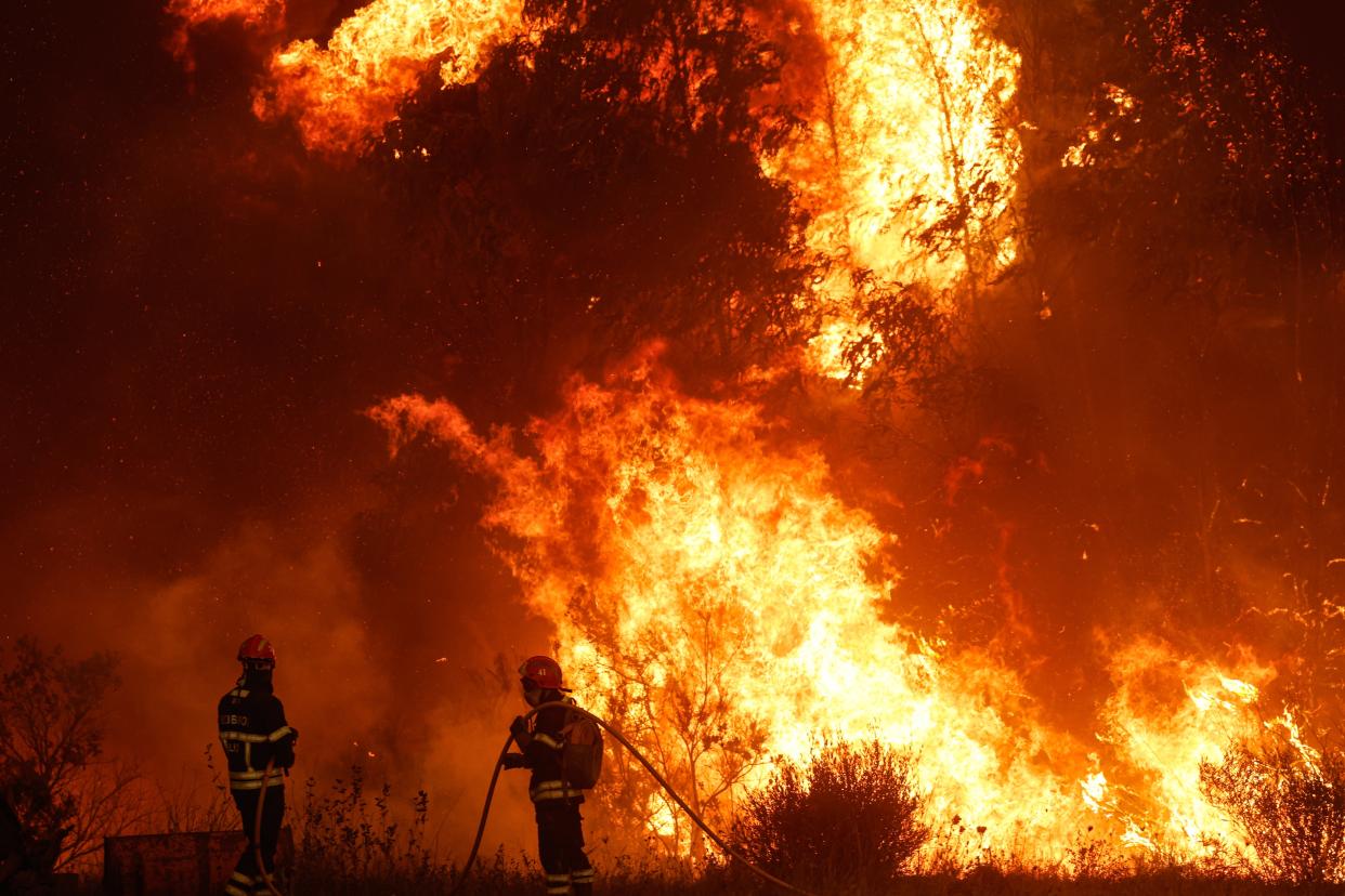 Firefighters work to put out the flames in the municipality of Odemira (EPA)