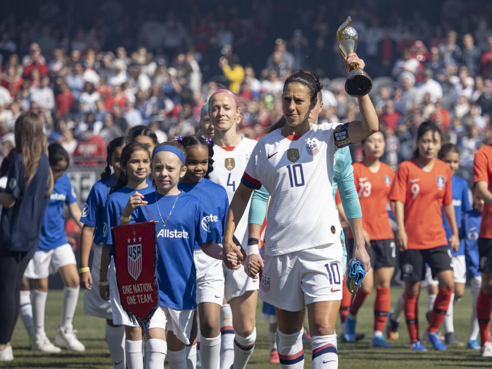 CHICAGO, IL - OCTOBER 06: The United States forward Carli Lloyd (10) takes the field with the World Cup before the five-game Victory Tour between Korea Republic and United States of America on Sunday, October 06, 2019 at Soldier Field in Chicago(Photo by Joseph Weiser/Icon Sportswire via Getty Images)