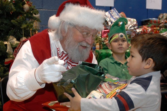 Bryan Marquez, 4, visits with Santa during the 2008 Bounty of Bethlehem Christmas dinner.