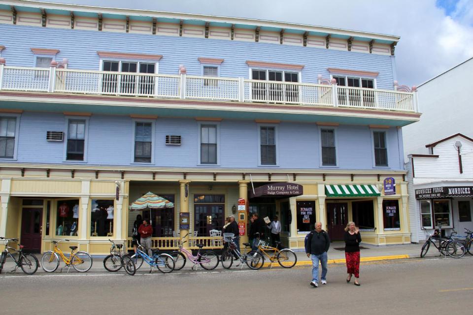 This Sept. 23, 2012 photo shows a downtown street on Mackinac Island, Mich. The island, located in Lake Huron, offers Victorian charm in modern times, with a century-long ban on motor vehicles. Bikes and even horse carriages are common sights on the island. (AP Photo/Anick Jesdanun)