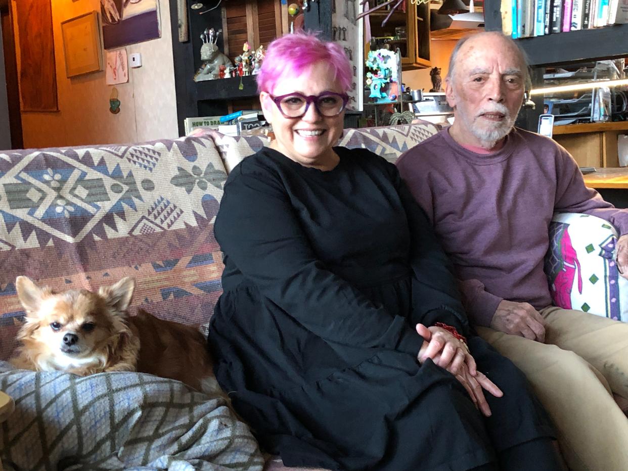 Susie Signorino and her father, Slug, pose for a photo in his home in LaPorte home. They share the couch with Tidy, the family dog.