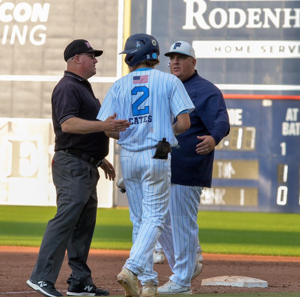 Franklin's Henry DiGiorgio speaks with the umpire and an assistant coach at first during Sunday's Division I State Championship game.