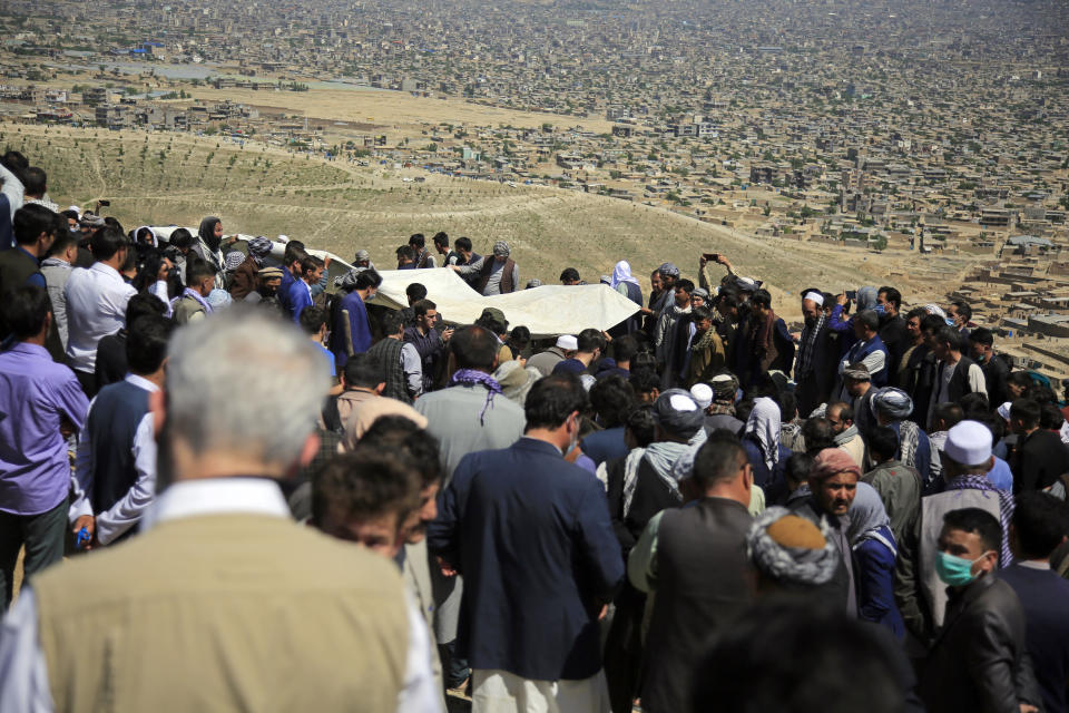 Afghan men bury a victim of deadly bombings on Saturday near a school, at a cemetary west of Kabul, Afghanistan, Sunday, May 9, 2021. The Interior Ministry said Sunday the death toll in the horrific bombing at the entrance to a girls' school in the Afghan capital has soared to some 50 people, many of them pupils between 11 and 15 years old, and the number of wounded in Saturday's attack has also climbed to more than 100. (AP Photo/Mariam Zuhaib)