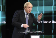 In this photo issued by ITV, Boris Johnson reacts during the election head-to-head debate live on TV, in Salford, Manchester, England, Tuesday, Nov. 19, 2019. Prime Minister Boris Johnson and opposition Labour Party leader Jeremy Corbyn are going head-to-head in their first live televised debate Tuesday evening, as the UK prepares for a General Election on Dec. 12. (ITV via AP)