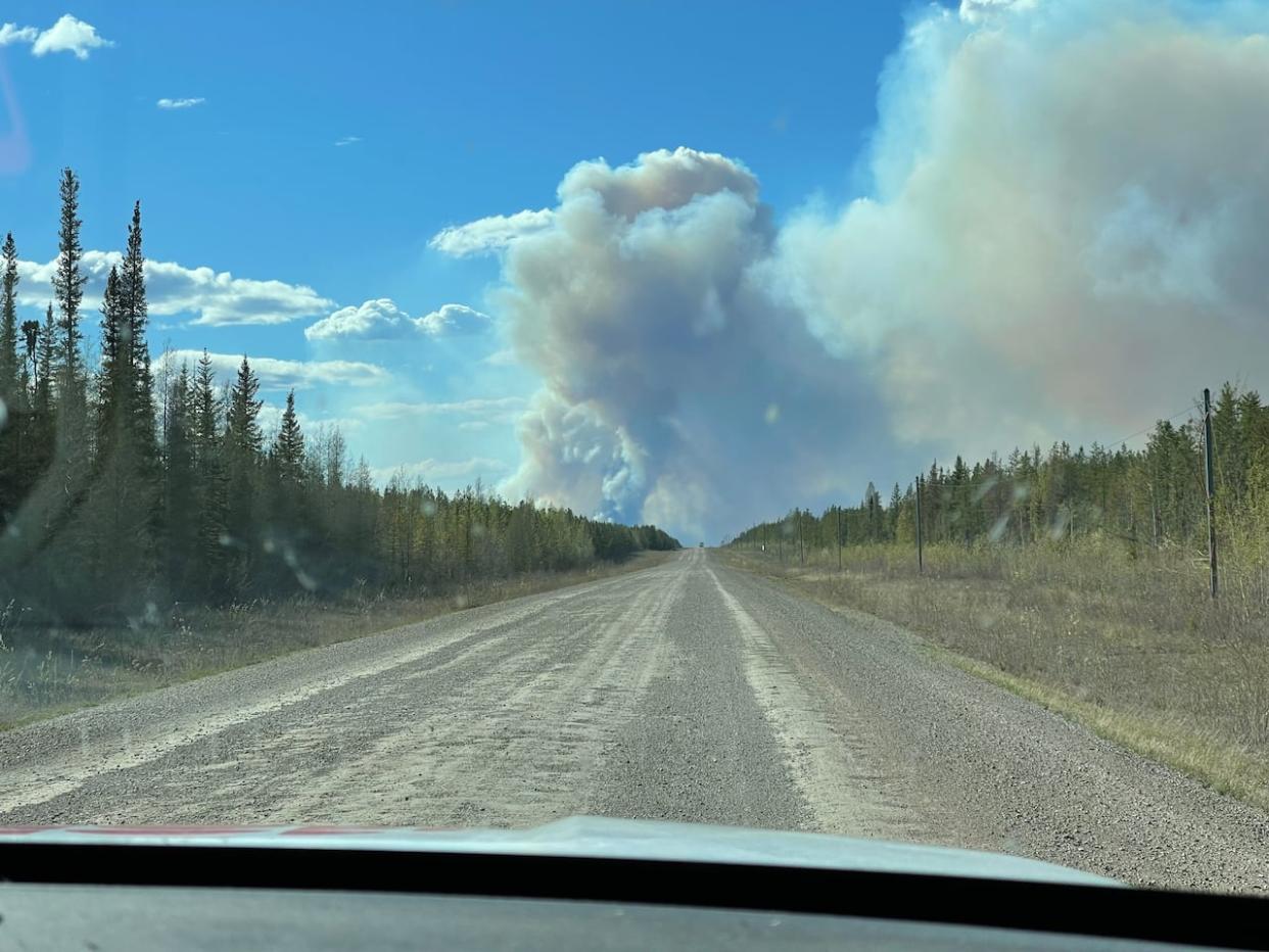 Smoke billows from a wildfire along N.W.T. Highway 1.  (Robert Holden/CBC - image credit)