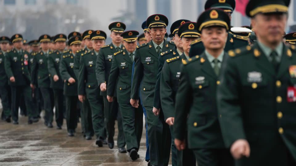 Delegates arrive at Beijing's Great Hall of the People on March 5 to attend the opening session of the National People's Congress annual meeting. - Tatan Syuflana/AP