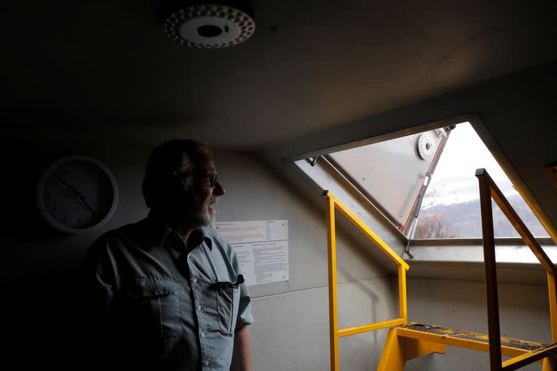 Donald Graham, 68, poses in his bunker that he and his wife Bron took shelter in as their home was destroyed by bushfires in Buchan, Victoria, Australia