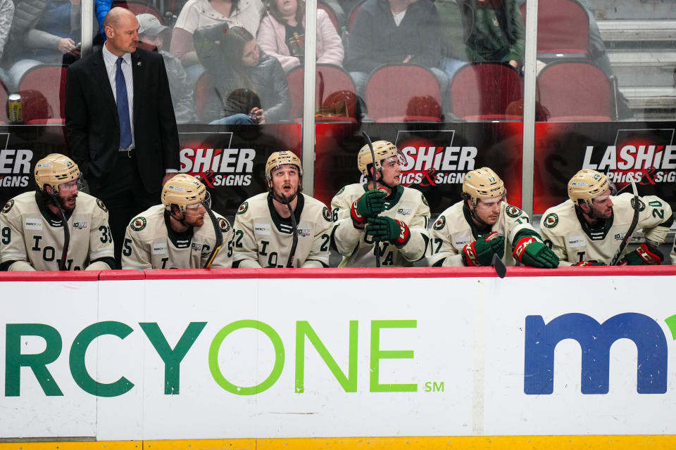 Iowa Wild defensemen Ryan O’Rourke (22) and forward Damien Giroux (16) sit next to each other on the bench during the game against Coachella Valley Firebirds.