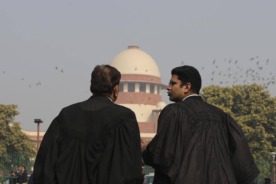 Supreme Court Lawyers speak to each other on the lawns of India's Supreme Court as it begins hearing dozens of petitions that seek revocation of a new citizenship law amendment in New Delhi, India, Wednesday, Jan. 22, 2020. The new law had led to nationwide demonstrations and a violent security backlash resulting in the death of more than 20 people. (AP Photo/Altaf Qadri)
