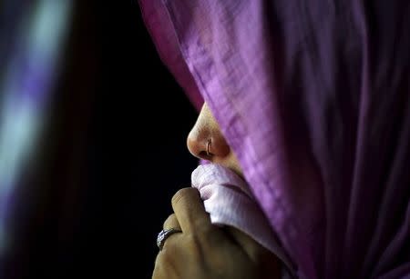 The mother of Meenakshi Kumari, 23, one of the two sisters allegedly threatened with rape by a village council in Uttar Pradesh, weeps inside her house at Sankrod village in Baghpat district, India, September 1, 2015. REUTERS/Adnan Abidi