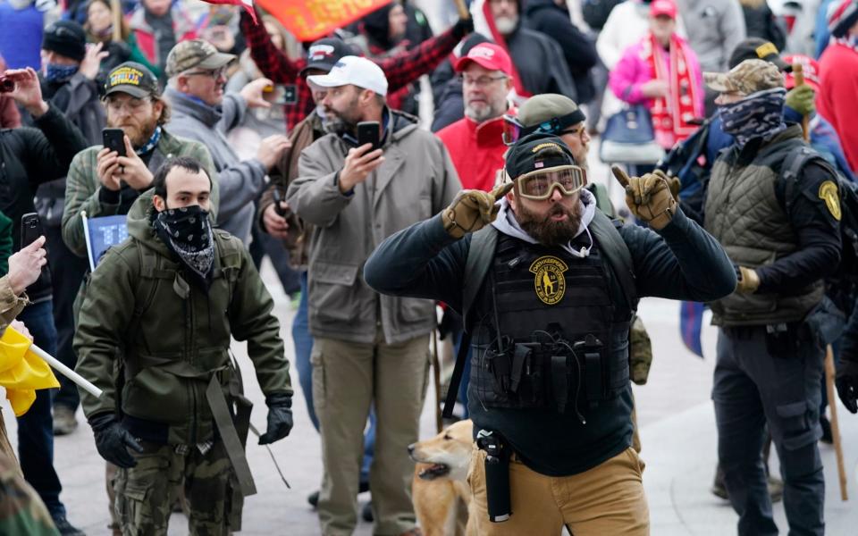 Trump supporters use their phones to record events as they gather outside the Capitol on January 6  - Manuel Balce Ceneta/AP