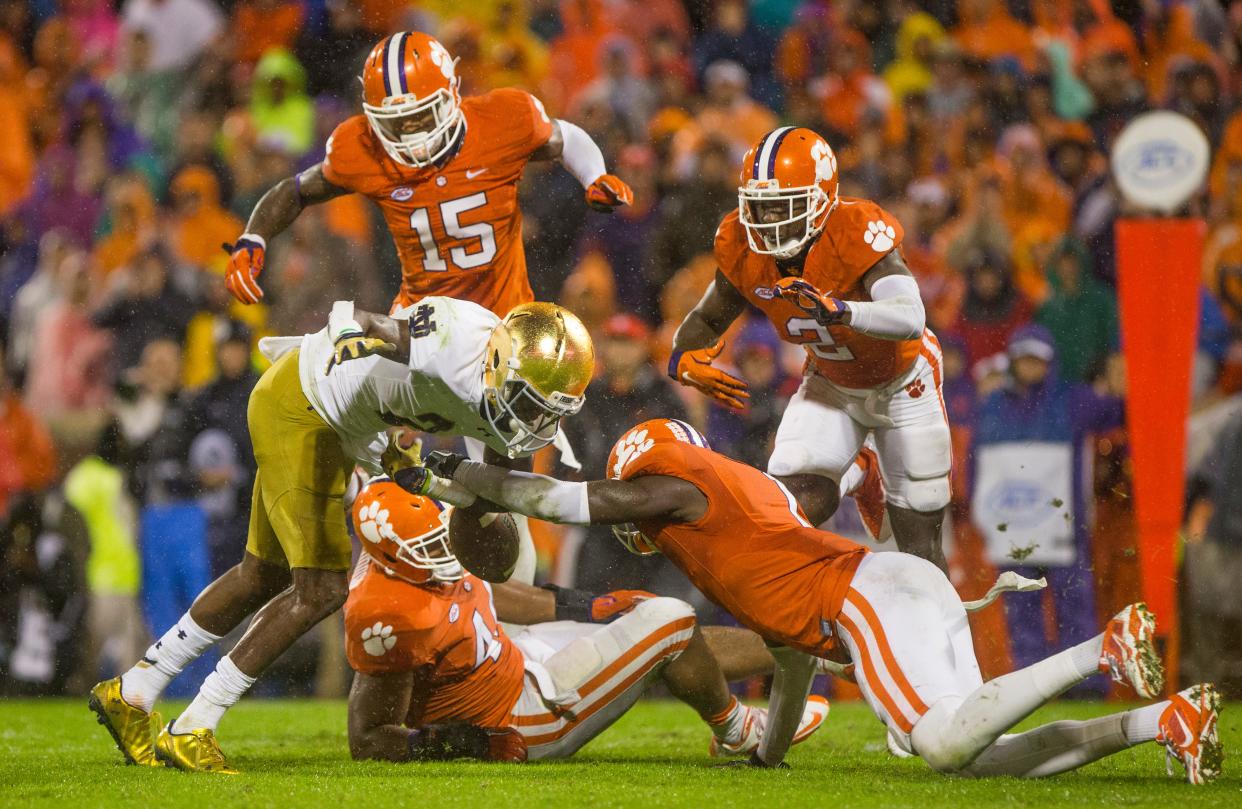 Notre Dame’s Chris Brown (2) has the ball poked out by a Clemson lineman in 2015.