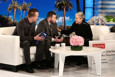 Stephen Schuck and security guard Jesus Campos of the Mandalay Bay Resort and Casino in Las Vegas, are interviewed by host Ellen DeGeneres during the taping of "The Ellen DeGeneres Show" in Burbank, California in this photo released October 18, 2017. Michael Rozman/Warner Bros./Handout via REUTERS