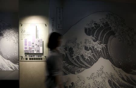 A woman walks in an elevator hall at First Cabin hotel, which was converted from an old office building, in Tokyo, July 8, 2015. REUTERS/Toru Hanai