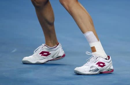 Poland's Agnieszka Radwanska wears a bandage on her leg during her third round match against Puerto Rico's Monica Puig at the Australian Open tennis tournament at Melbourne Park, Australia, January 22, 2016. REUTERS/Issei Kato