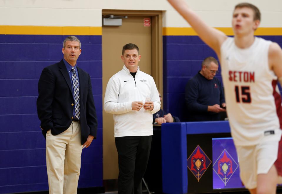 Seton head coach Josh Jurgens (right) talks with Blue River Valley head coach Brian Klein (left) while watching their teams warm up before their game Jan. 25, 2022.