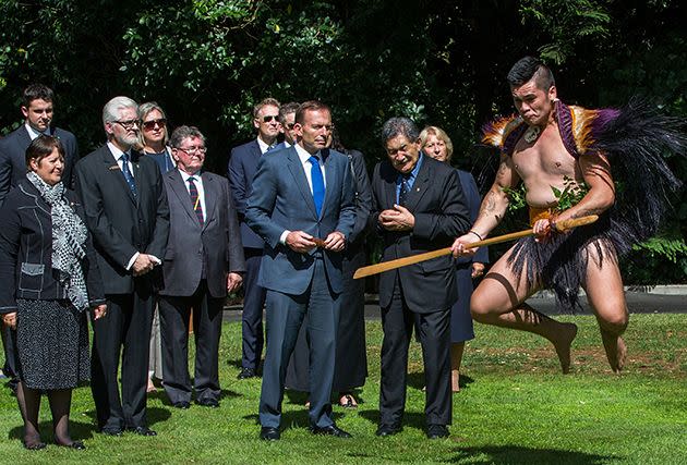 Prime Minister Abbott watches the Powhiri at a welcome ceremony at Government House in Auckland. Photo: Getty