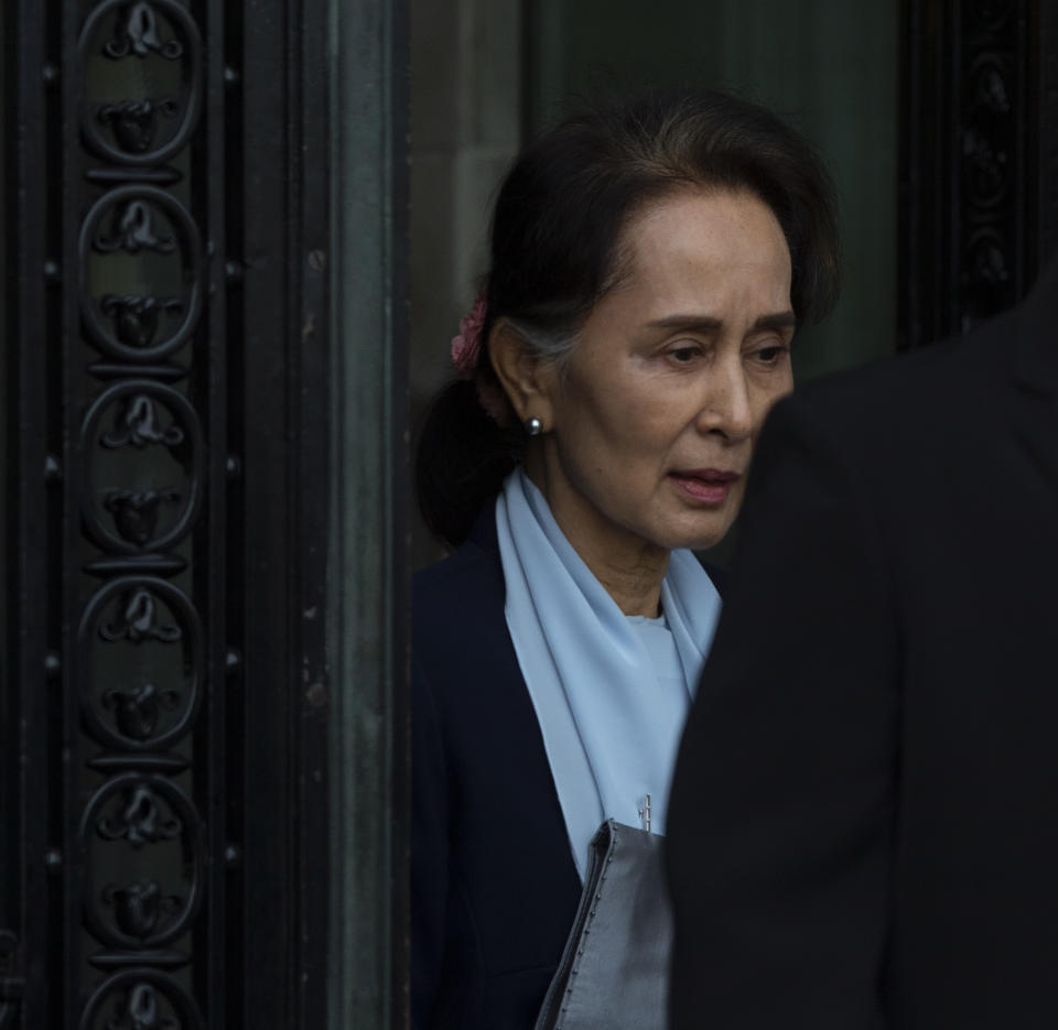 Myanmar's leader Aung San Suu Kyi leaves the International Court of Justice after addressing judges on the second day of three days of hearings in The Hague, Netherlands, Wednesday, Dec. 11, 2019. Aung San Suu Kyi defended Myanmar and denied genocide accusations in a case filed by Gambia at the ICJ, the United Nations' highest court, accusing Myanmar of genocide in its campaign against the Rohingya Muslim minority. (AP Photo/Peter Dejong)