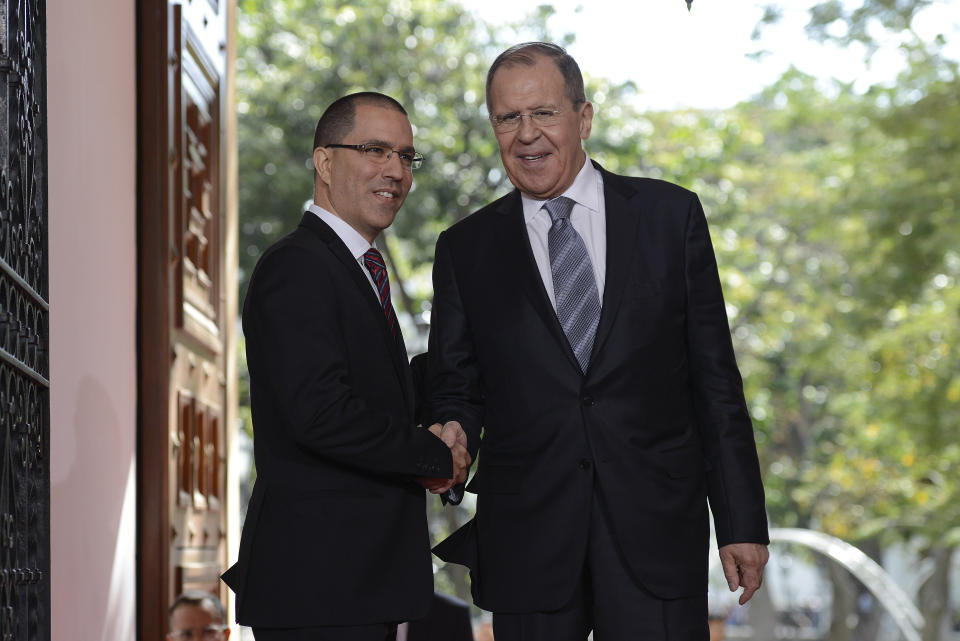 Russia's Foreign Minister Sergey Lavrov, right, shakes hands with Venezuela's Foreign Minister Jorge Arreaza upon arrival to the Foreign Ministry in Caracas, Venezuela, Friday, Feb. 7, 2020. (AP Photo/Matias Delacroix)