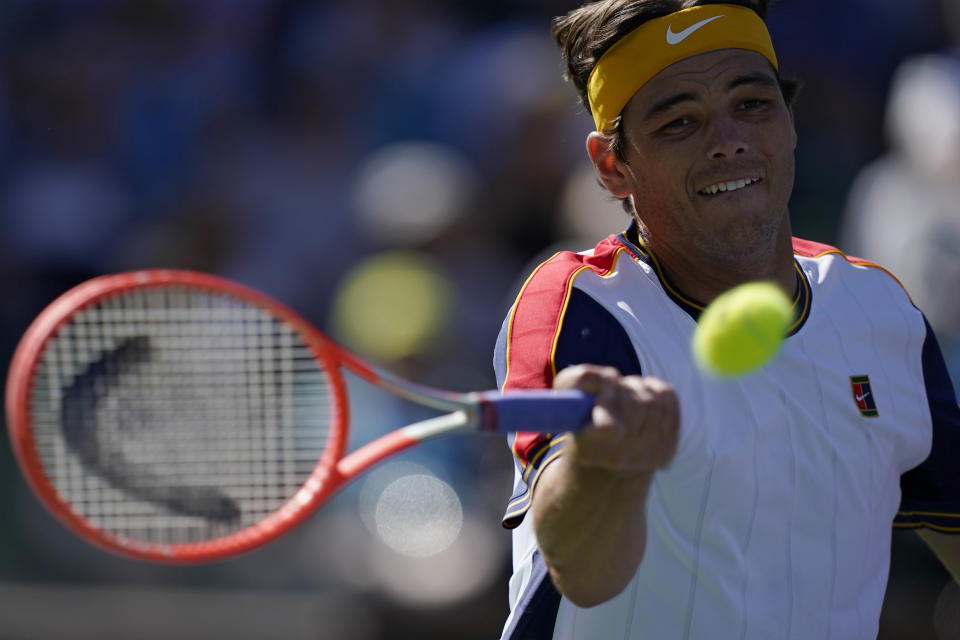 Taylor Fritz returns a shot to Matteo Berrettini, of Italy, at the BNP Paribas Open tennis tournament Tuesday, Oct. 12, 2021, in Indian Wells, Calif. (AP Photo/Mark J. Terrill)