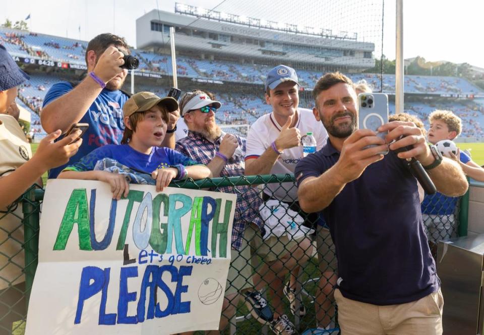 Wrexham goalkeeper Ben Foster take selfies and signs autographs for fans prior to their match against Chelsea on Wednesday, July 19, 2023 in Kenan Stadium in Chapel Hill, N.C.