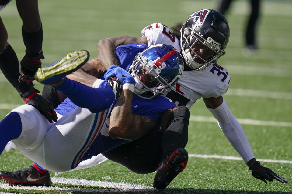 New York Giants wide receiver Kenny Golladay (19) is tackled by Atlanta Falcons defensive back T.J. Green, right, during the second half of an NFL football game, Sunday, Sept. 26, 2021, in East Rutherford, N.J. (AP Photo/Seth Wenig)