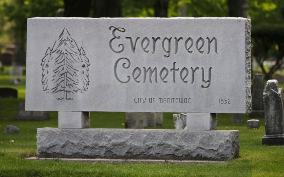 The stone sign for Evergreen Cemetery as seen, Monday, May 22, 2023, in Manitowoc, Wis. The Cemetery opened in 1852 and today features some 80 acres of land.