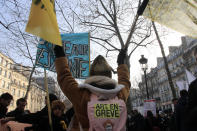 A striking artist takes part a demonstration with a sticker reading "art on strike", Friday, Jan. 24, 2020 in Paris. French unions are holding last-ditch strikes and protests around the country Friday as the government unveils a divisive bill redesigning the national retirement system. (AP Photo/Michel Euler)