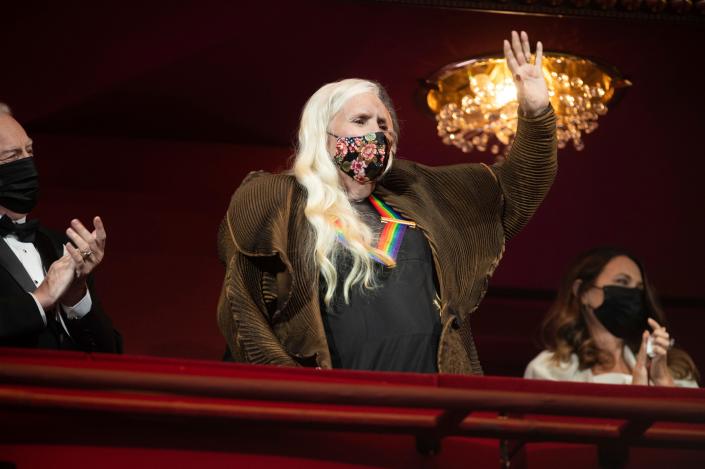 2021 Kennedy Center honoree singer-songwriter Joni Mitchell waves to the audience during the Honors Gala for the 44th Kennedy Center Honors on Sunday, Dec. 5, 2021, in Washington.