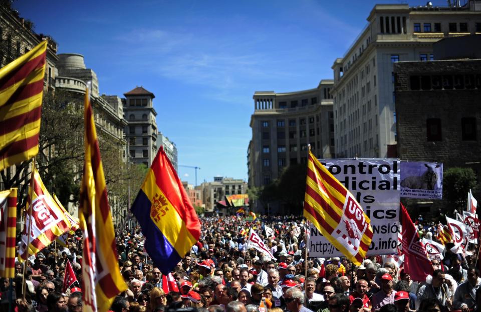 People protest during a May Day rally in the center of Barcelona, Spain, Tuesday, May 1, 2012. Tens of thousands of workers marked May Day in European cities Tuesday with a mix of anger and gloom over austerity measures imposed by leaders trying to contain the eurozone's intractable debt crisis. Spanish Prime Minister Mariano Rajoy is trying desperately to cut a bloated deficit, restore investor confidence in Spain's public finances, lower the 24.4 jobless rate, and fend off fears it will join Greece, Ireland and Portugal in needing a bailout. (AP Photo/Manu Fernandez)