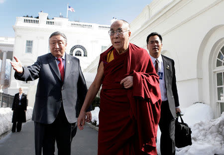 FILE PHOTO: Tibetan spiritual leader the Dalai Lama (C) walks outside the White House after his meeting with U.S. President Barack Obama in Washington February 18, 2010. REUTERS/Yuri Gripas/File Photo