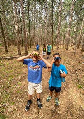 A pair of youngsters go birdwatching during the NORA Recreation Summer School.