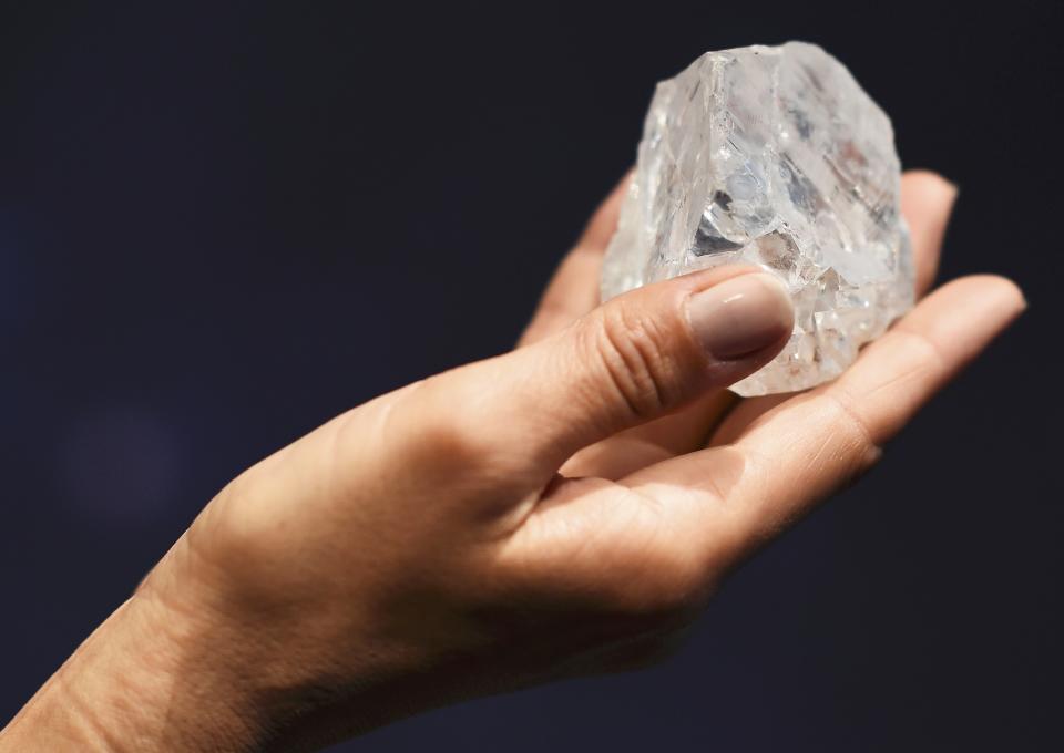 A model shows off the 1109 carat "Lesedi La Rona", the largest gem quality rough diamond discovered in over 100 years during a sale preview at Sotheby's auction house in London