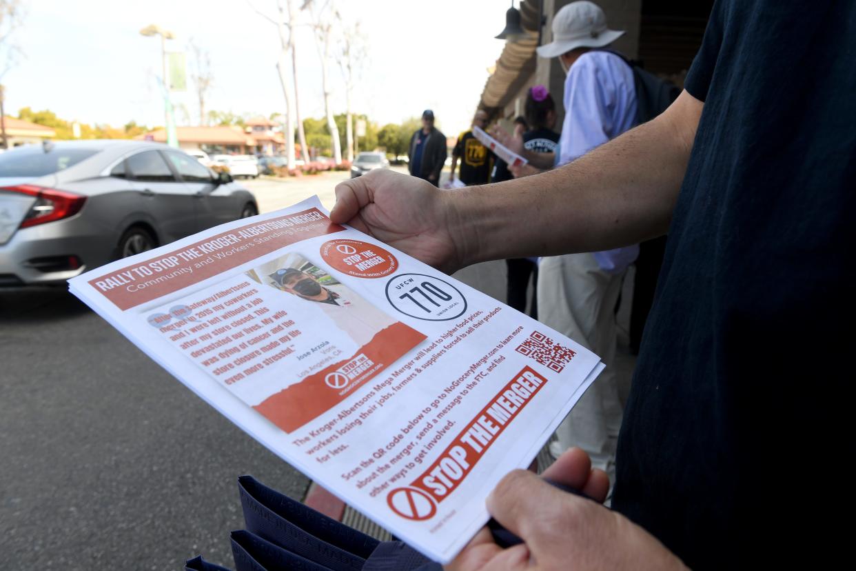 Members of United Food and Commercial Workers Local 770 hand out information opposing a proposed grocery chain merger in front of a Ralphs in Thousand Oaks on Thursday, April 6, 2023. Workers gathered at the Moorpark Road store to rally against the merger of Kroger and Albertsons.