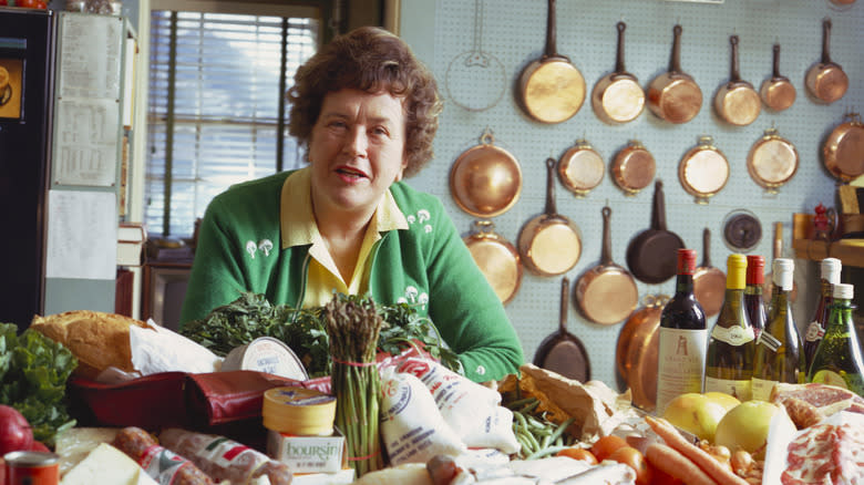 Julia Child sits in her kitchen