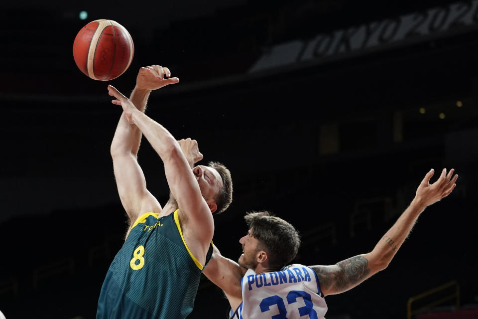 Australia's Matthew Dellavedova (8) is fouled by Italy's Achille Polonara, right, during a men's basketball preliminary round game at the 2020 Summer Olympics, Wednesday, July 28, 2021, in Saitama, Japan. (AP Photo/Charlie Neibergall)