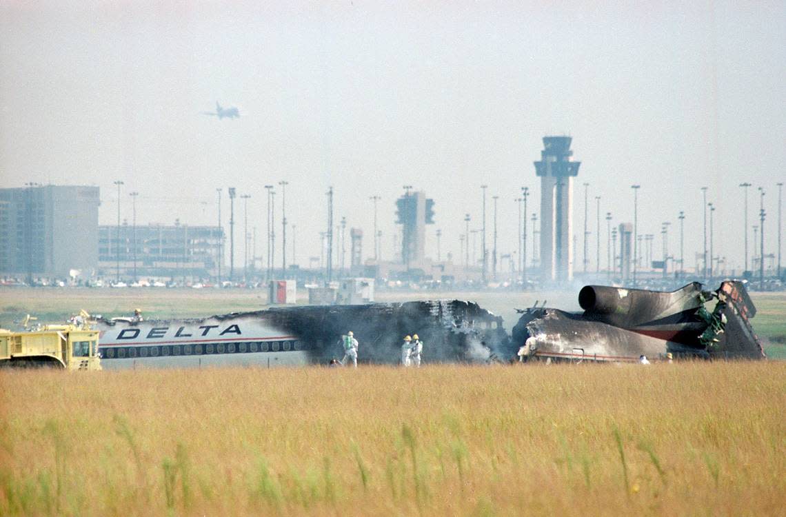 Aug. 31, 1988: Firefighters are seen after extinguishing the blaze from Delta 1141’s crash after a failed takeoff at Dallas-Fort Worth International Airport. The FAA Control Tower is visible in the background.